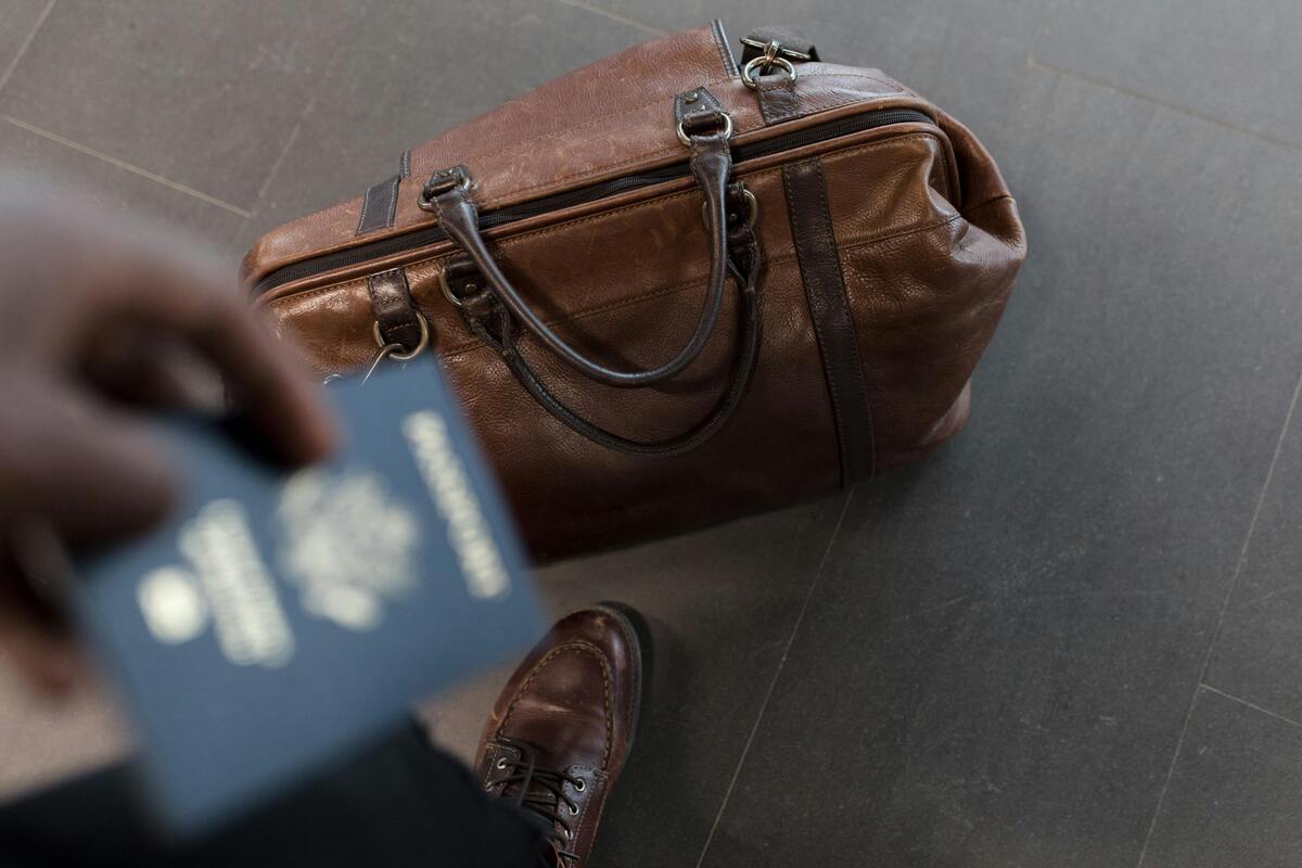 British citizen with a passport and a travel bag for their trip to Spain